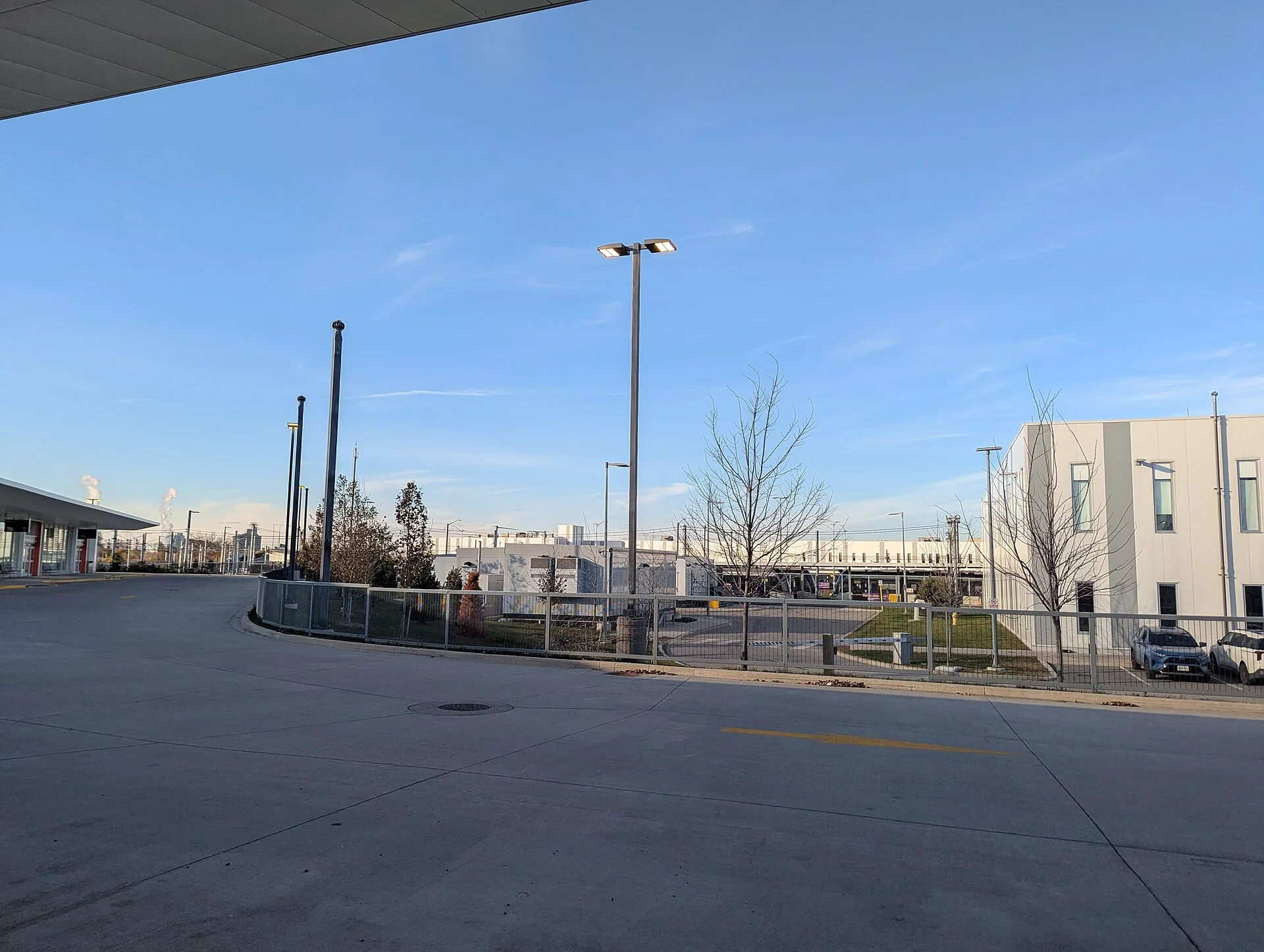 This photo, taken from the Mount Dennis TTC bus terminal, looks north toward the Eglinton Maintenance and Storage Facility (EMSF), where Line 5 Eglinton light-rail vehicles are stored and maintained. The yard’s elevated guideway and parked LRVs are visible in the background. The scene highlights how. Self-Storage Local SEO: Map Listing Checklist