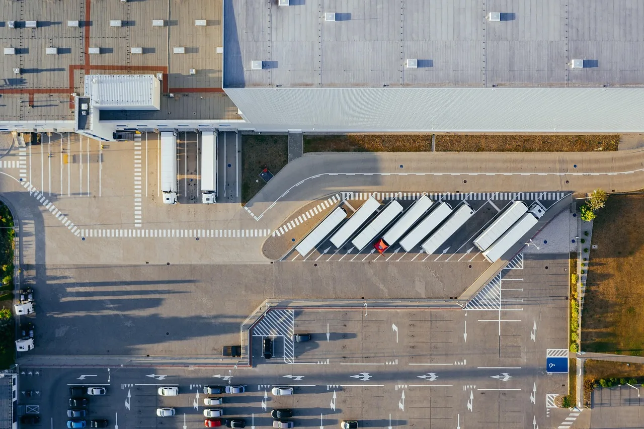production, facility, logistic, distribution center, transit, truck, transport, top view, industrial, semi, aerial view, heavy, depot, germany, warehouse, container truck, shipping containers, storehouse, road, loading bay, factory, unloading, distribute, unload, europe, aerial photography, production, logistic, truck, truck, warehouse, warehouse, warehouse, warehouse, warehouse. Self-Storage Operations: Four Recurring Facility Cycles
